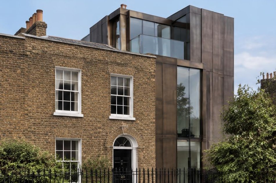 Retained historic facade beside a bold contemporary addition in Angel