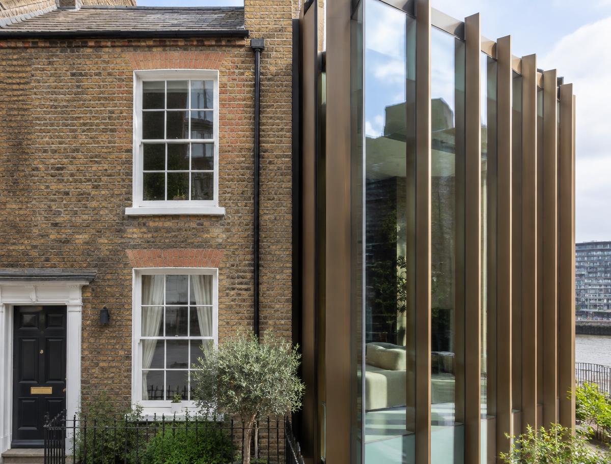 Retained historic facade directly beside a contemporary glazed residential addition in Bankside