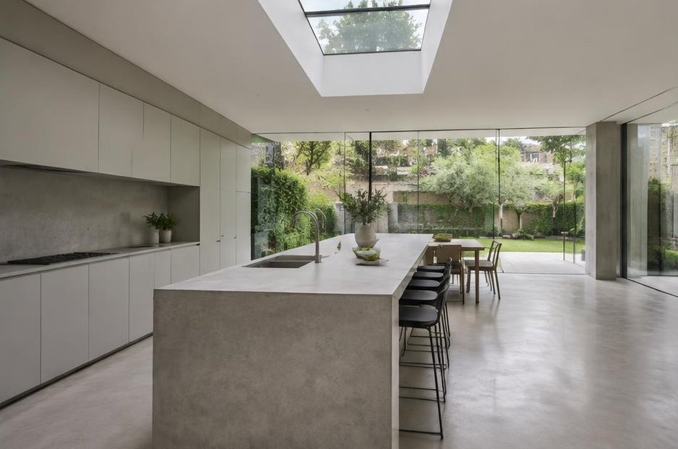 Contemporary kitchen with open stair and garden glazing in Barnsbury