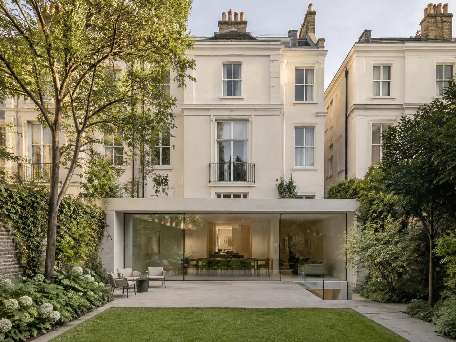 Minimalist concrete and glass garden extension behind a cream stucco Belgravia townhouse