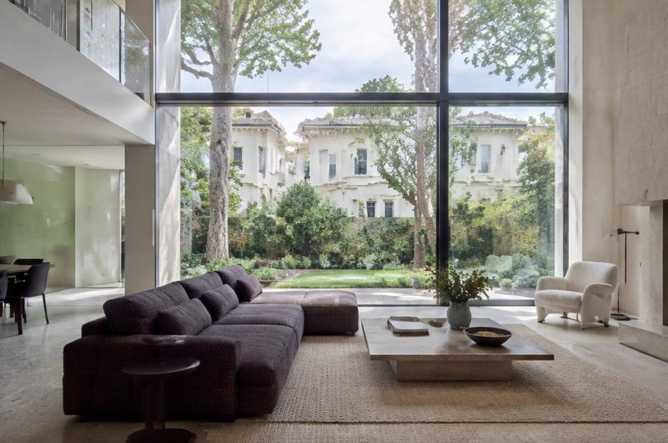 Minimalist contemporary living space with local residential garden views in Belsize Park