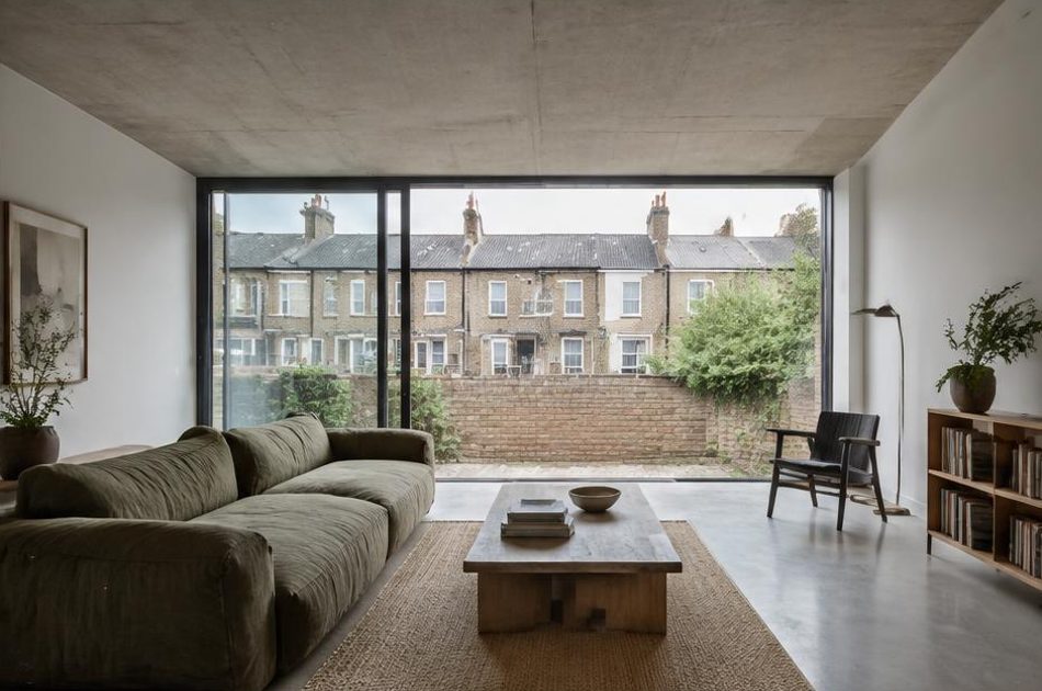 Minimalist contemporary room with straight fabric seating and views onto Bermondsey residential homes and gardens