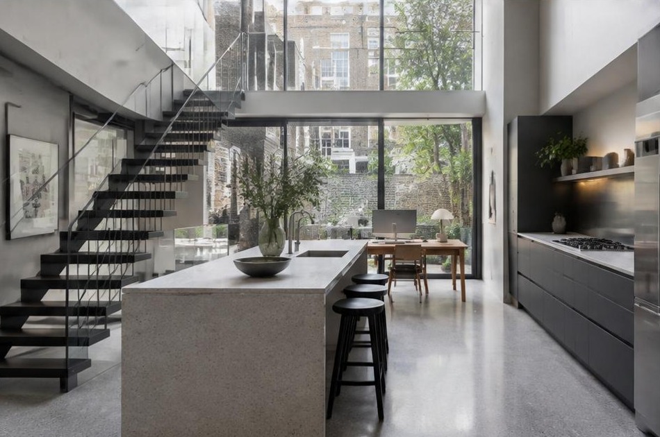 Completed contemporary kitchen and open staircase with garden glazing in Bloomsbury
