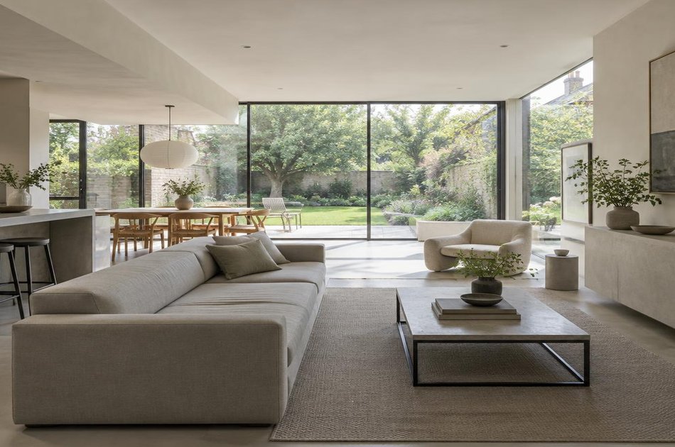 Contemporary living space opening onto a garden in Bush Hill Park