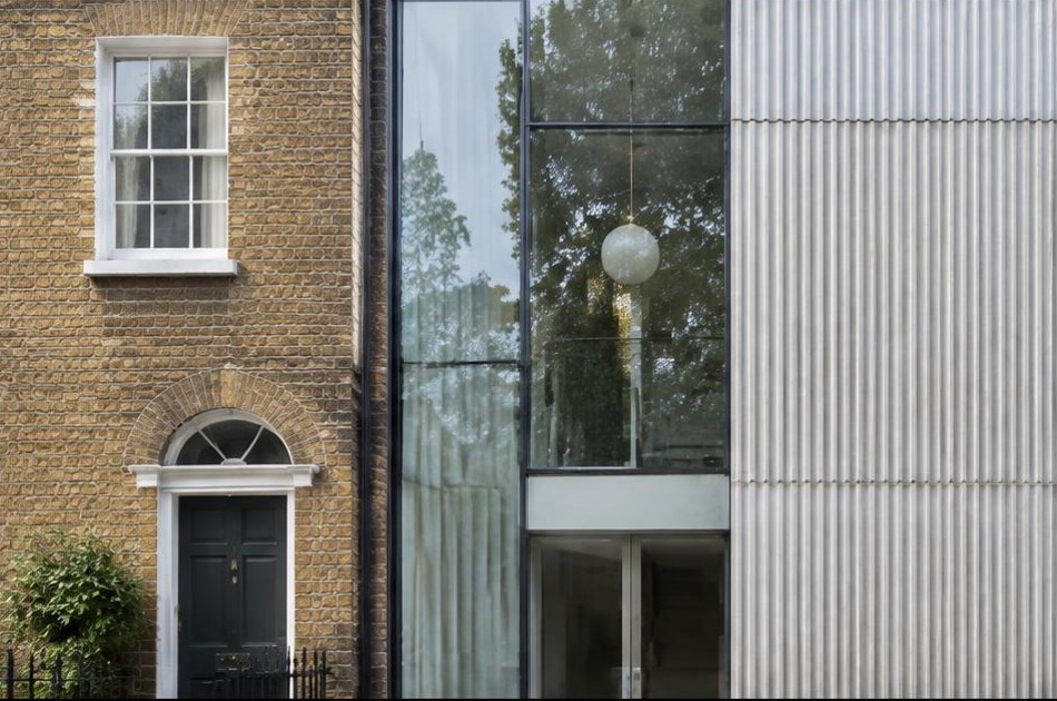 Retained historic facade beside a dominant contemporary glazed addition in Camden