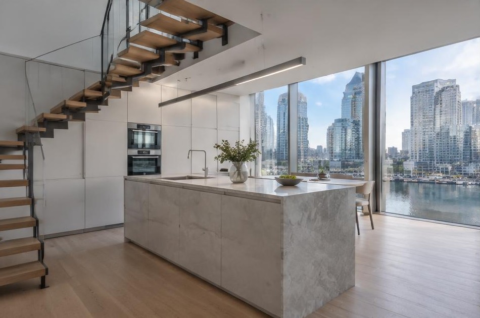 Completed contemporary kitchen with open staircase and garden glazing in Canary Wharf