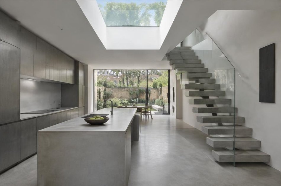 Contemporary kitchen with open stair and garden glazing in Canonbury