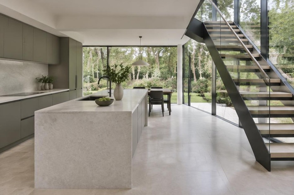 Completed contemporary kitchen with open staircase and garden glazing in Chessington
