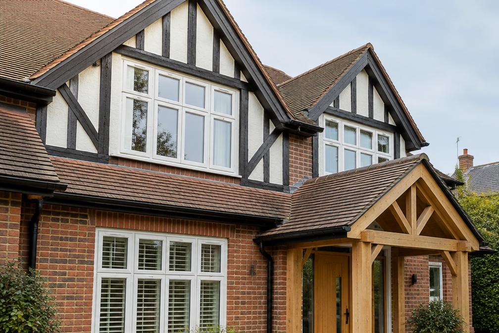 Half-timbered gable beside a new oak-framed porch in Chingford