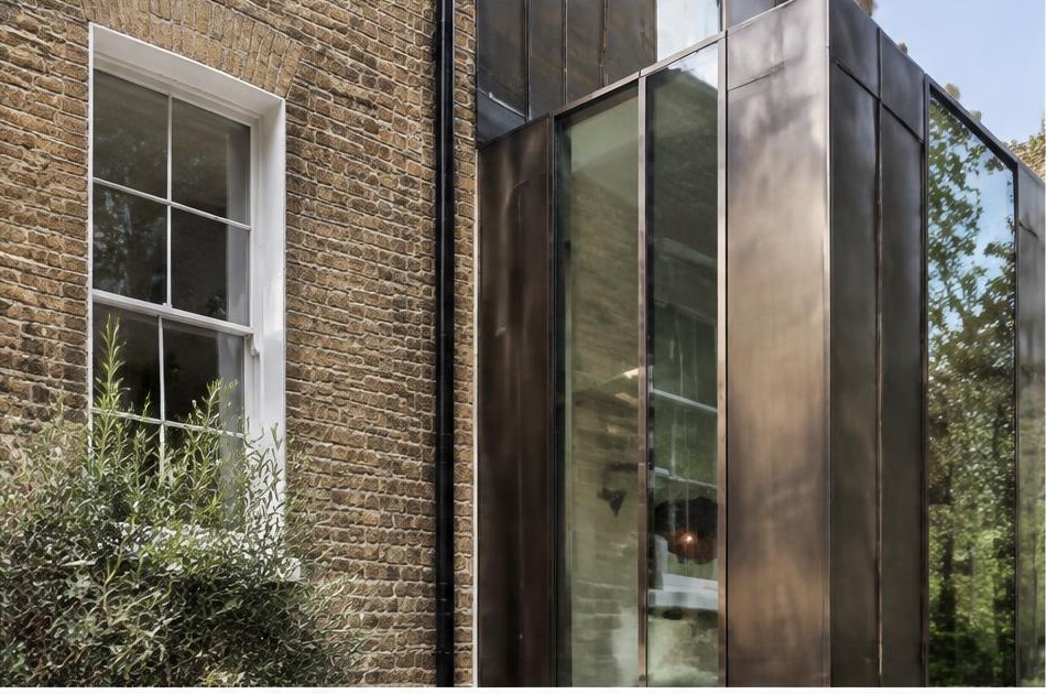 Retained historic facade directly beside a contemporary glazed residential addition in Clapham