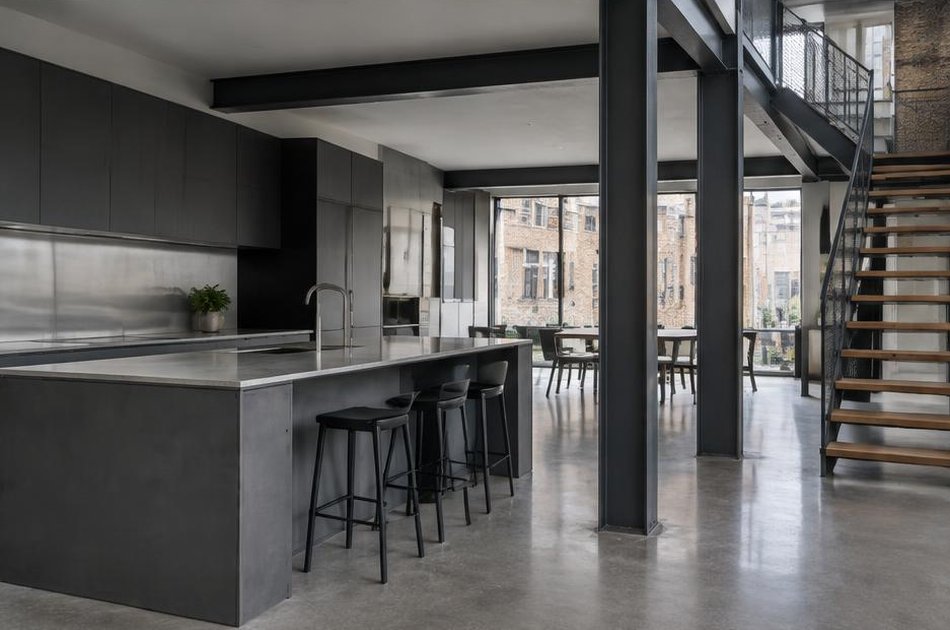Contemporary kitchen with open stair and garden glazing in Clerkenwell