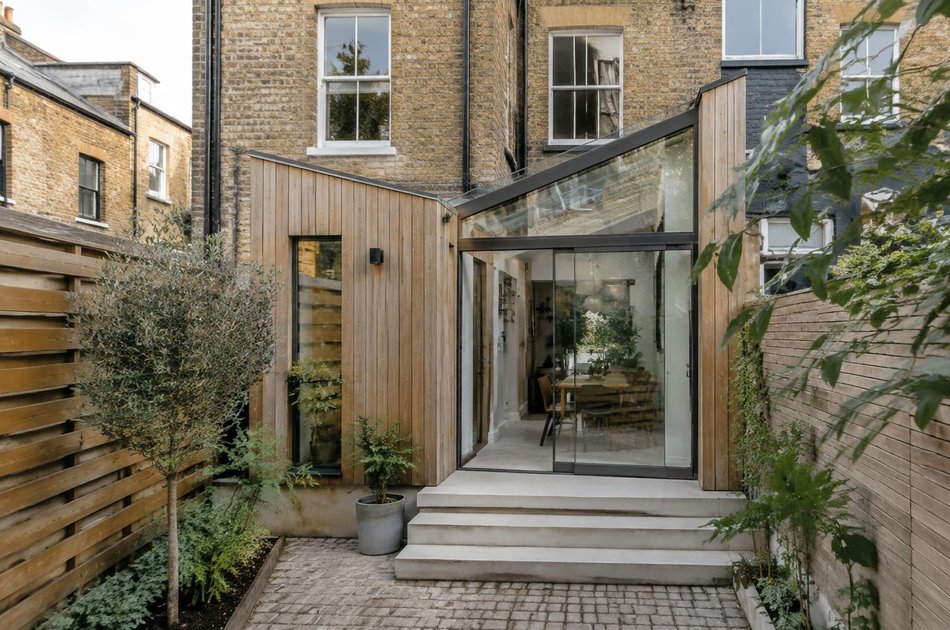 Timber-clad side-return extension with a glass roof in Colliers Wood