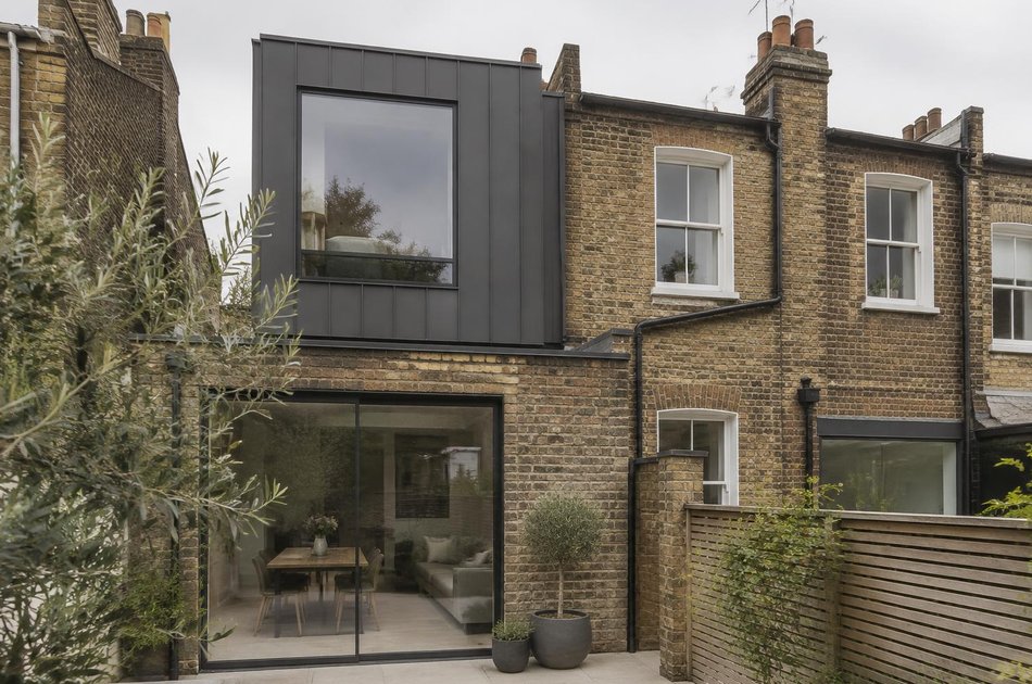 Victorian terrace rear beside a metal-clad loft extension and glazed rear extension in Colliers Wood