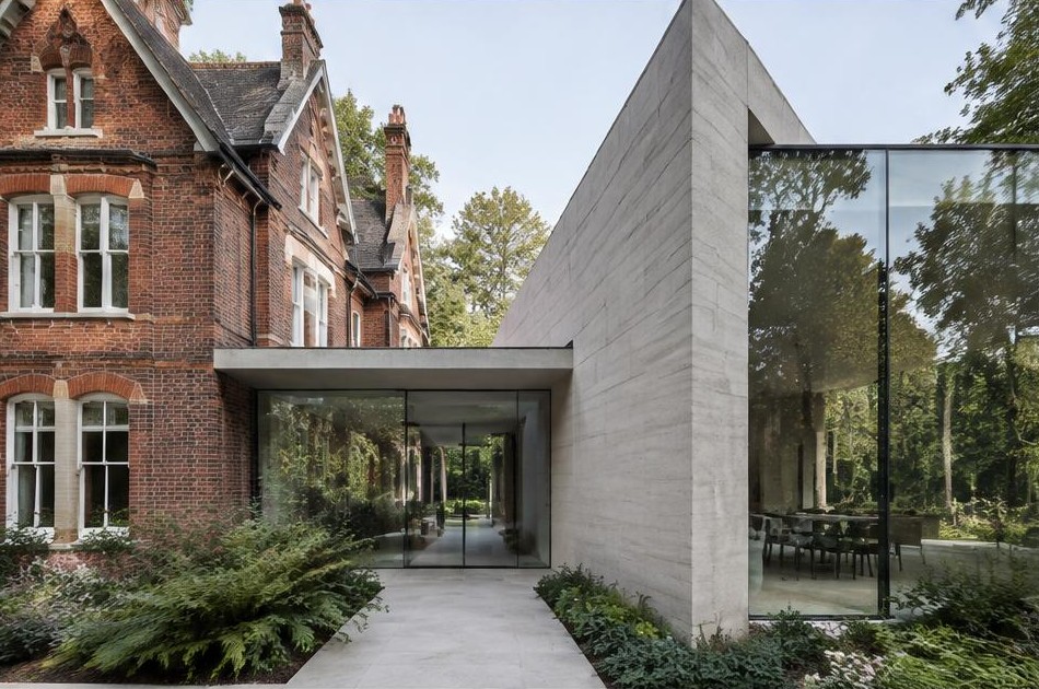 Retained original facade beside a dominant contemporary glazed addition in Coombe