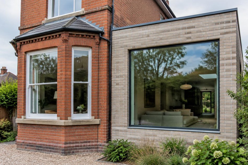 Red-brick villa beside a pale brick extension in Crouch End