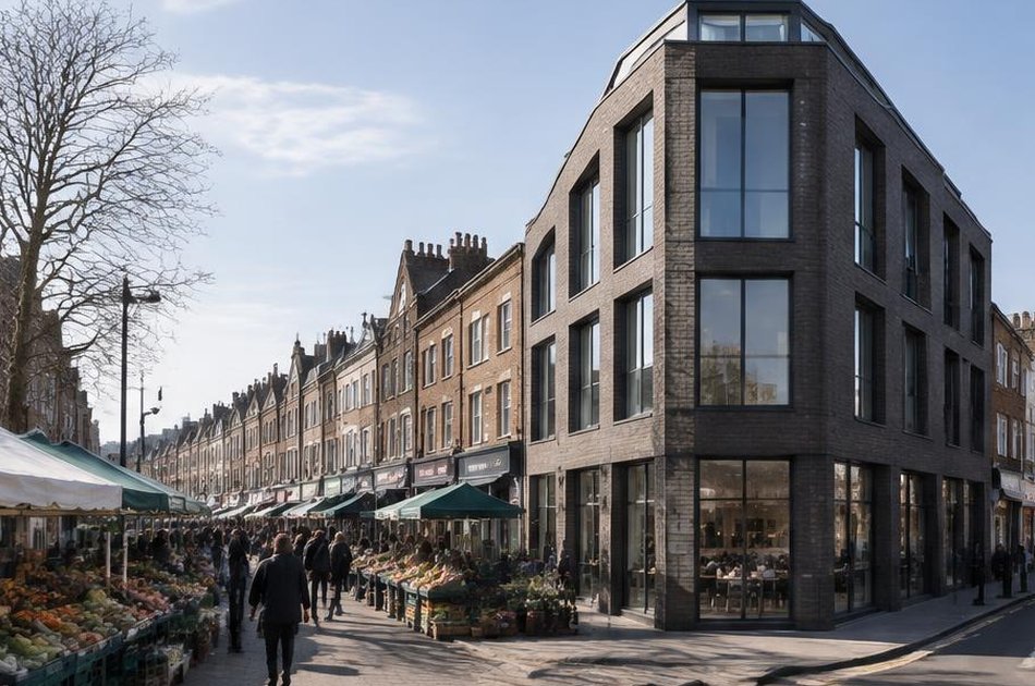 Market stalls on Deptford High Street beside a contemporary dark-brick corner building