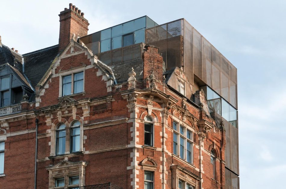 Victorian mansion block with a glass and bronze-mesh rooftop addition in Ealing Broadway