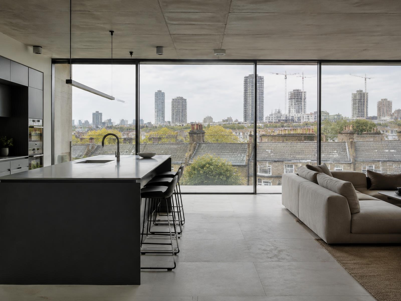 Top-floor apartment with concrete ceiling and views over terrace rooftops to new towers