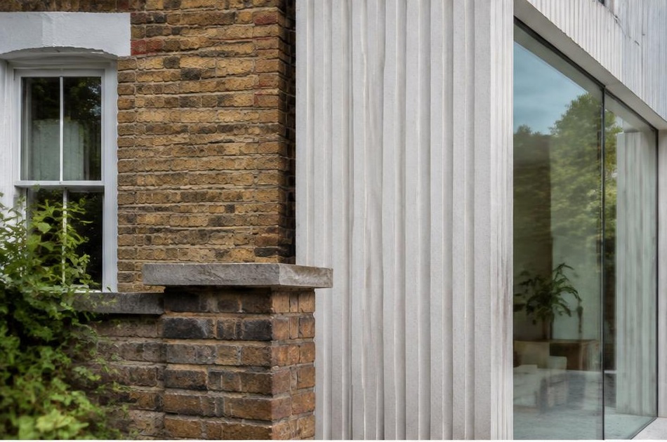 Retained historic facade directly beside a contemporary glazed residential addition in Earlsfield