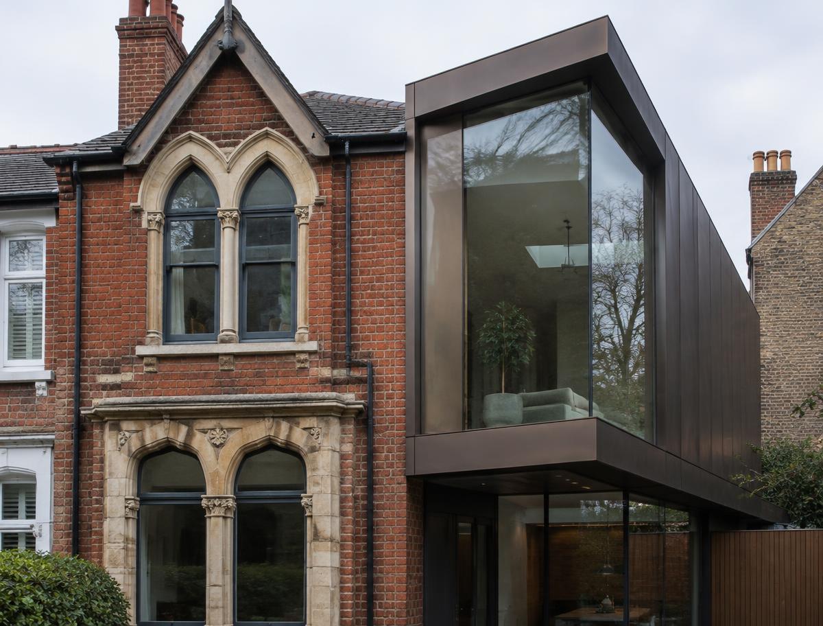 Retained historic facade directly beside a contemporary glazed residential addition in East Dulwich