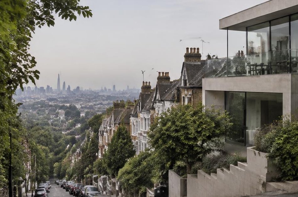 Hillside Victorian street with a cantilevered contemporary house and distant city skyline in Forest Hill