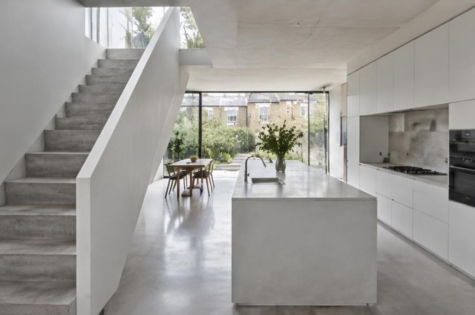 Completed contemporary kitchen and open staircase with garden glazing in Gospel Oak