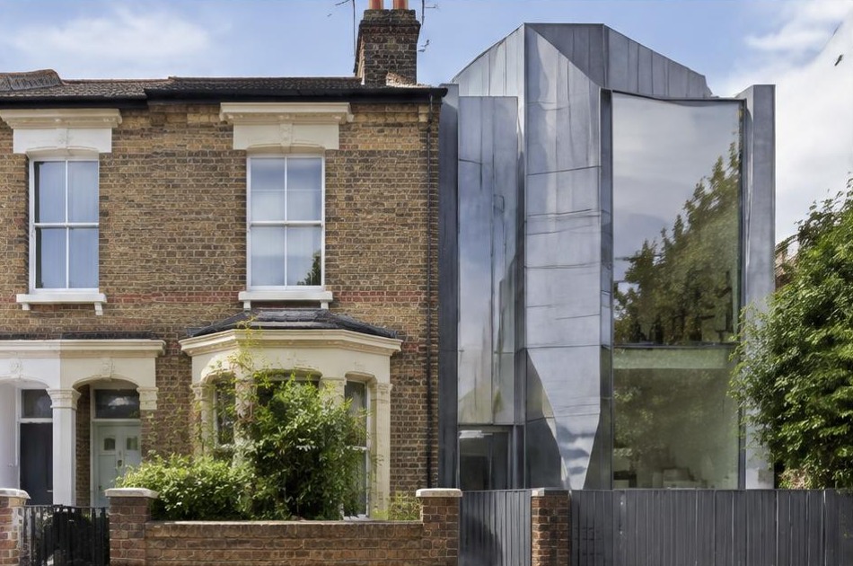 Retained historic facade beside a dominant contemporary glazed addition in Gospel Oak