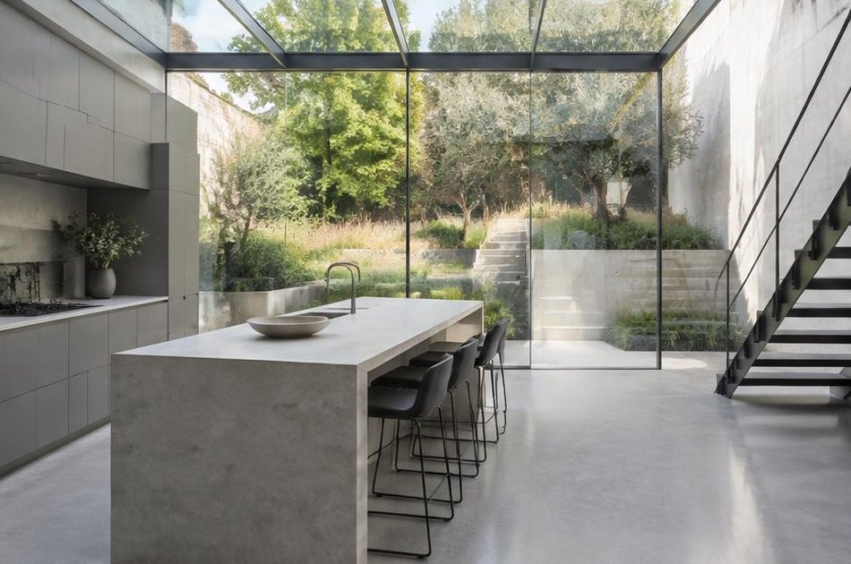 Contemporary kitchen extension with a glass roof onto a hillside garden in Greenwich