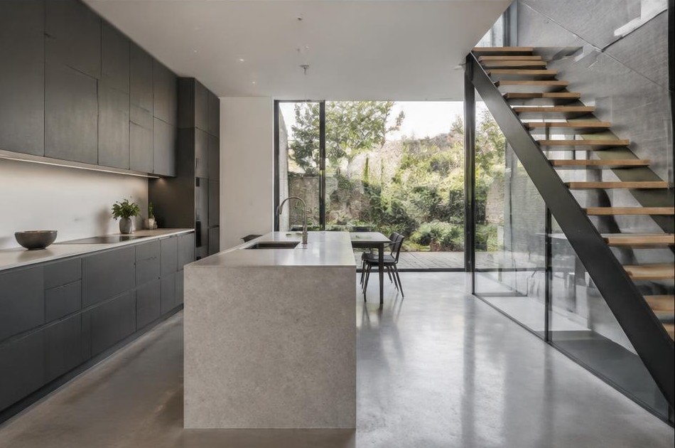 Completed contemporary kitchen with open staircase and garden glazing in Hackney Central