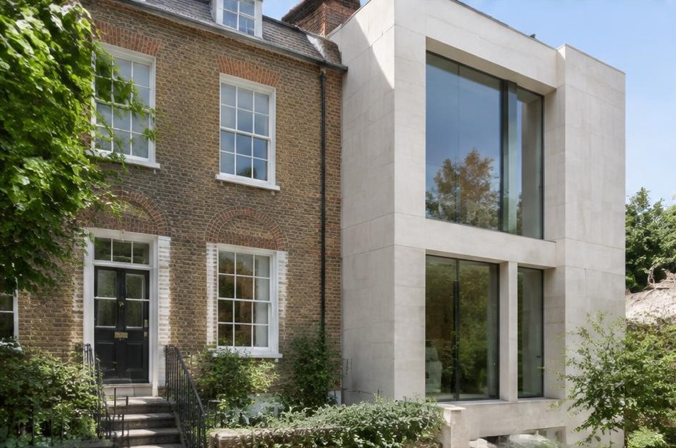 Retained historic facade beside a dominant contemporary glazed addition in Hampstead
