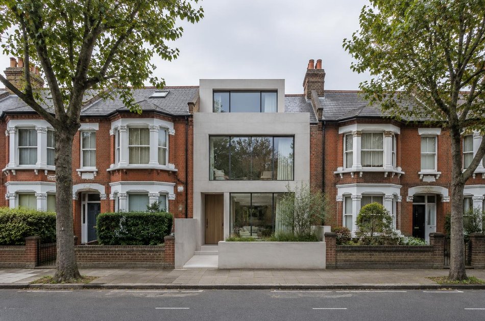 Pale concrete contemporary house in a red-brick Edwardian terrace in Haringey
