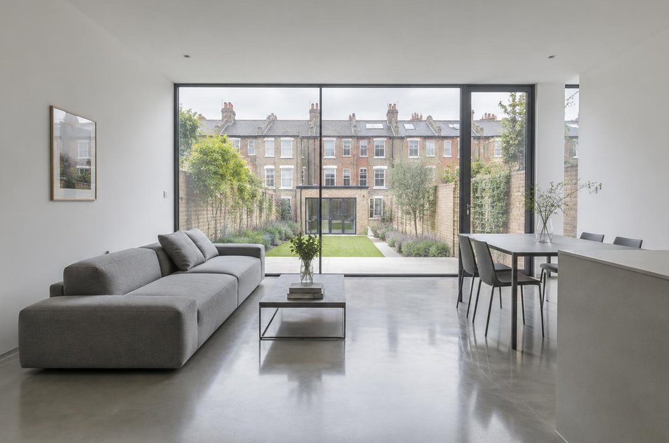 Living space with a linear sofa overlooking terraced gardens in Haringey