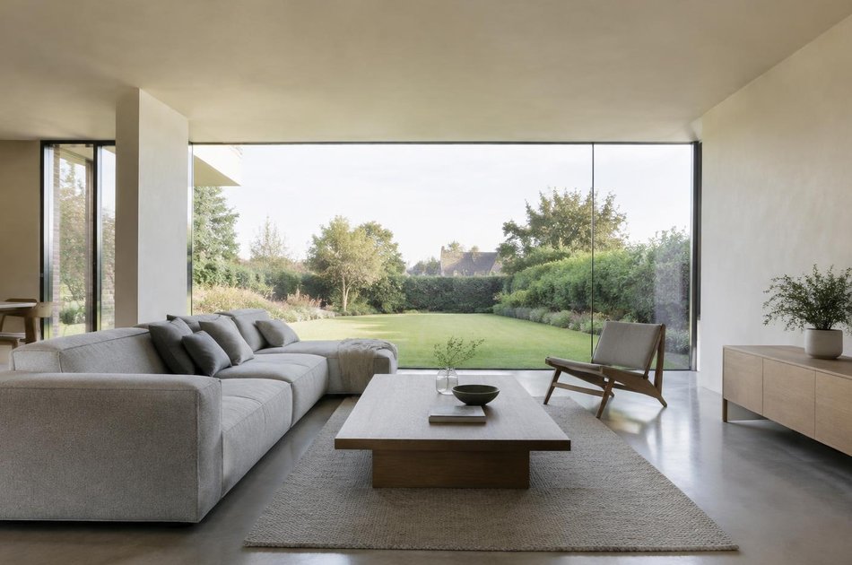 Contemporary living space opening onto a garden in Havering
