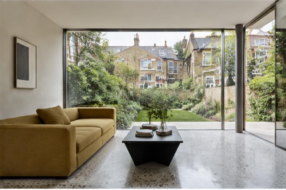 Minimalist contemporary room with straight fabric seating and views onto Herne Hill residential homes and gardens