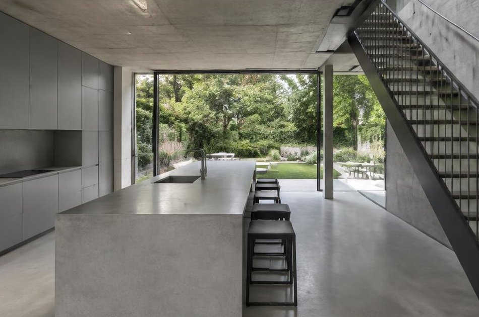 Contemporary kitchen with open stair and garden glazing in Highbury