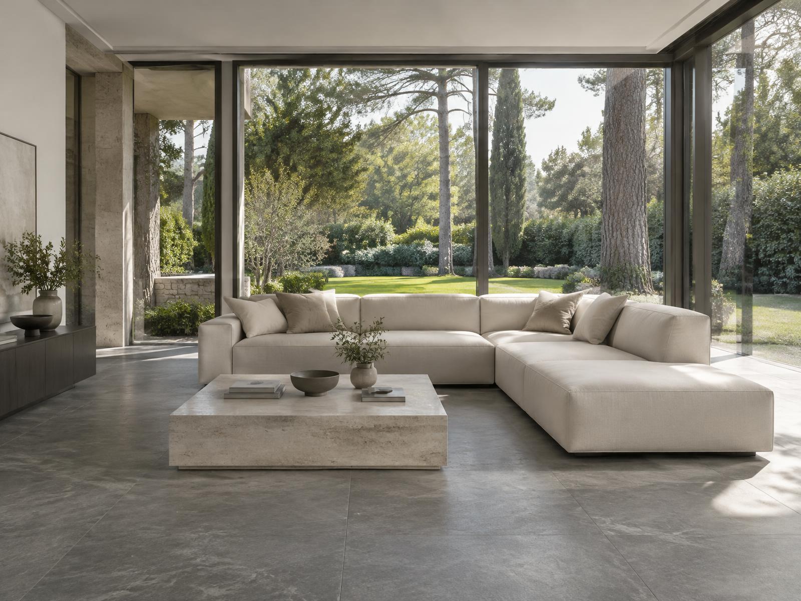 Minimalist villa living room with a square-edged linen sofa and glazing onto a mature garden