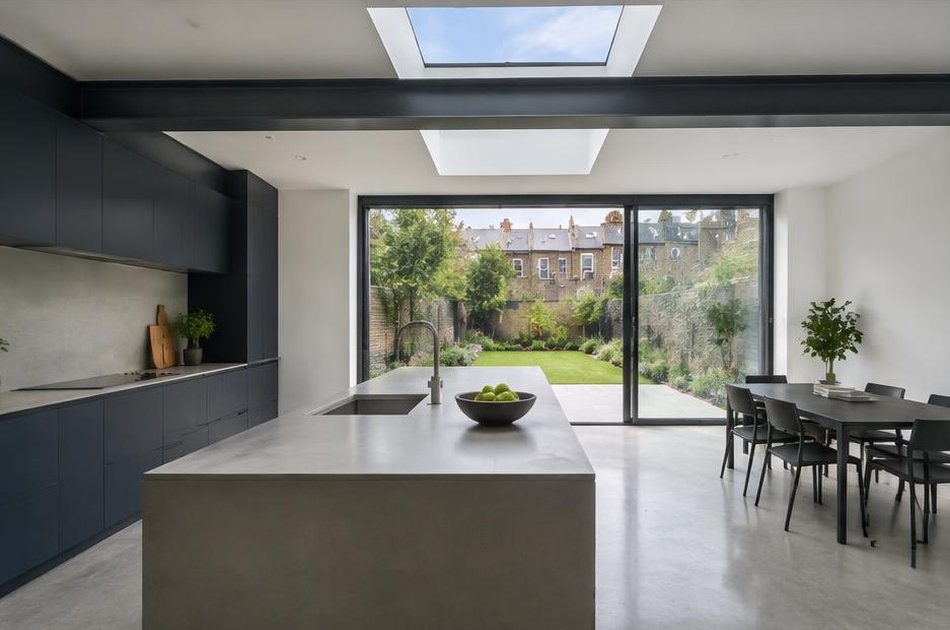 Contemporary kitchen with open stair and garden glazing in Holloway