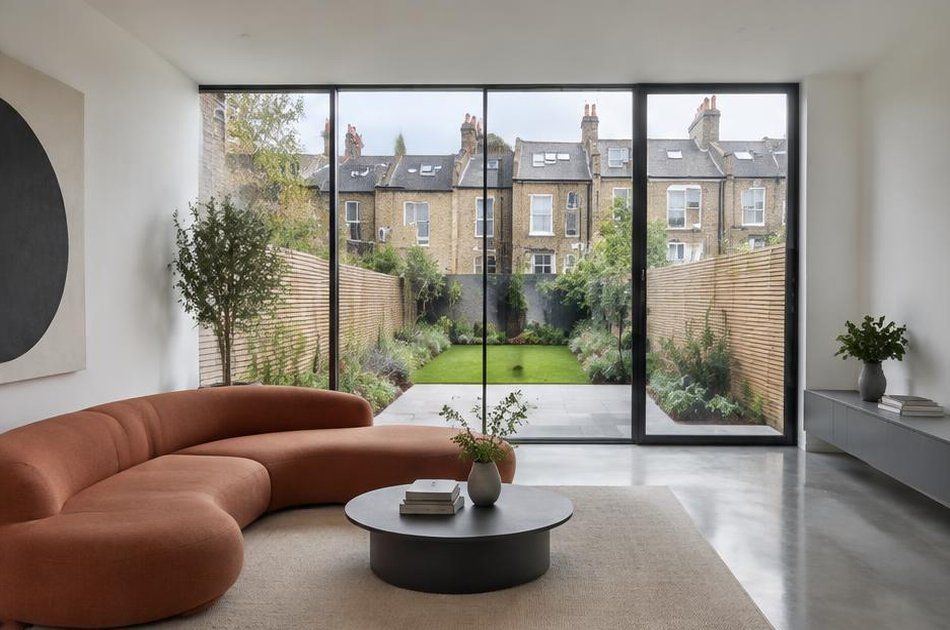 Minimalist living space with broad glazing onto local streets in Holloway