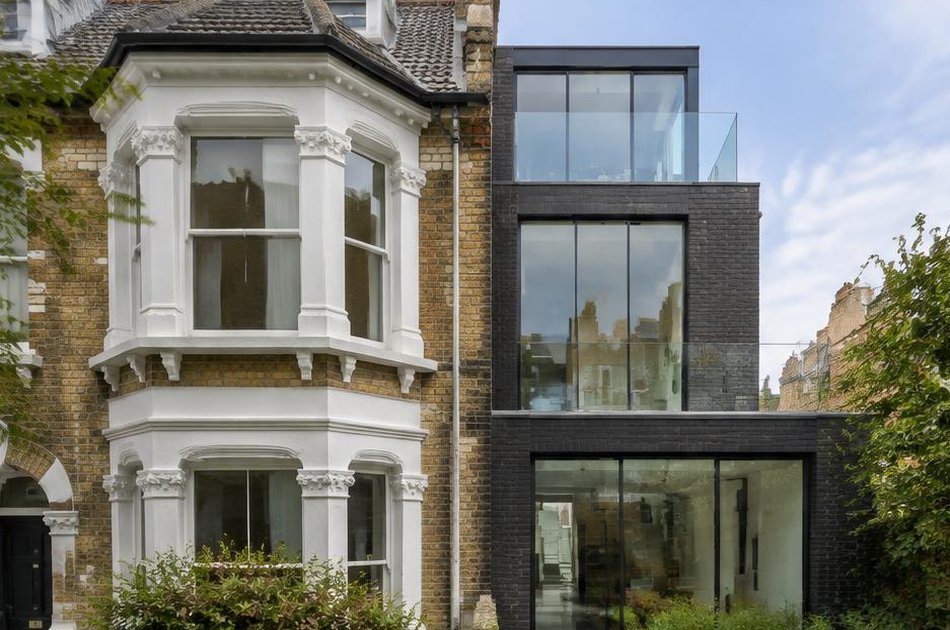 Retained historic facade beside a bold contemporary addition in Holloway