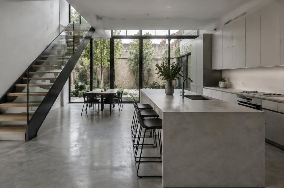 Completed contemporary kitchen with open staircase and garden glazing in Hoxton