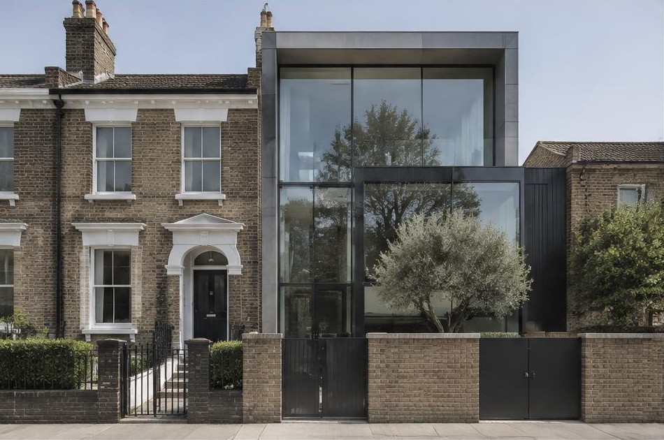 Retained original facade beside a dominant contemporary glazed addition on the Isle of Dogs