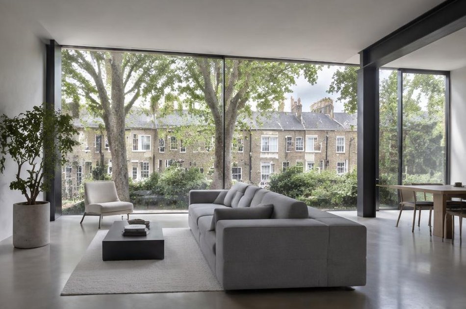 Minimalist living space with broad glazing onto local streets in Islington