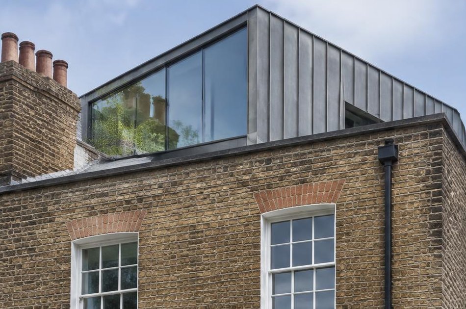 Retained historic facade beside a bold contemporary addition in Islington