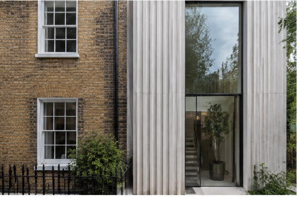 Retained historic facade directly beside a contemporary glazed residential addition in Kennington