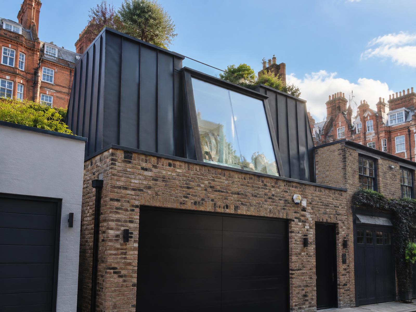 Kensington mews house with a dark zinc and glass rooftop addition, mansion blocks behind
