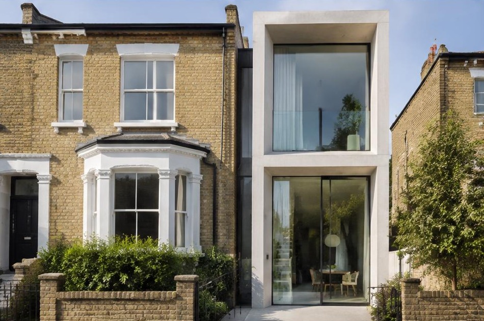 Retained historic facade beside a dominant contemporary glazed addition in Kentish Town