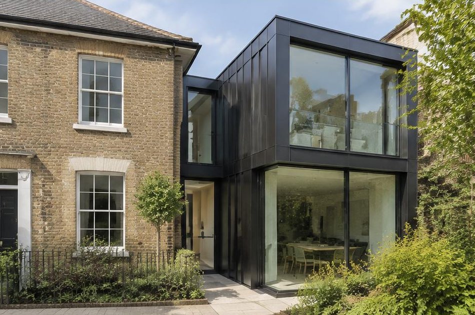 Brick townhouse beside a contemporary metal and glass extension in Kidbrooke