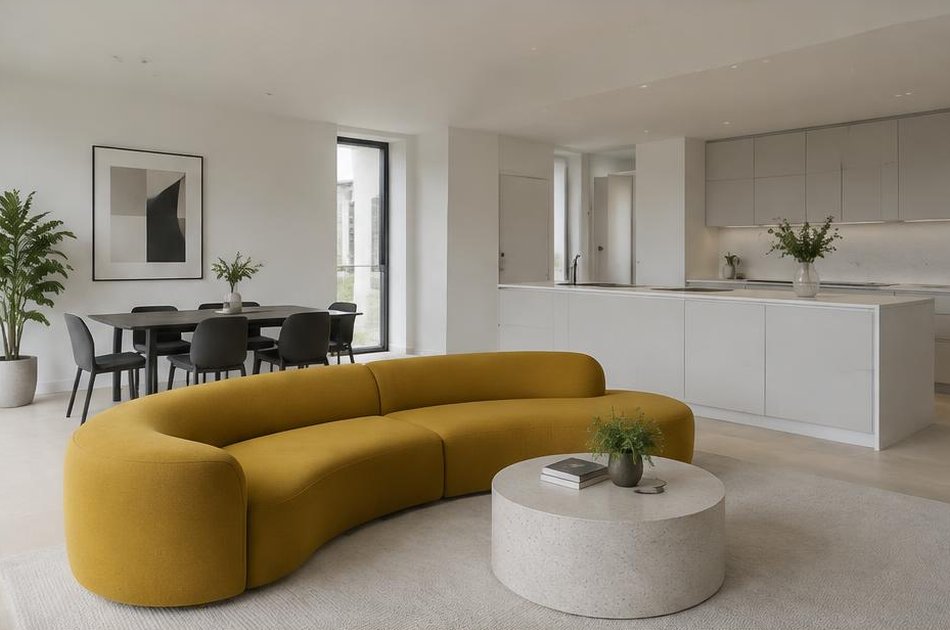 Open-plan interior with a curved mustard sofa in Kidbrooke