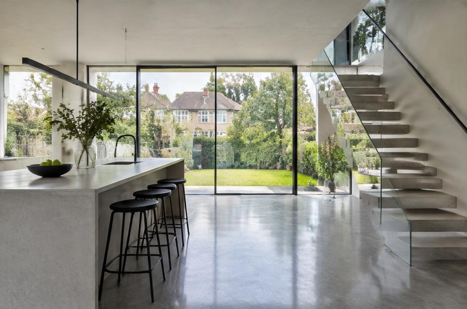 Completed contemporary kitchen and open staircase with garden glazing in Kingston Vale