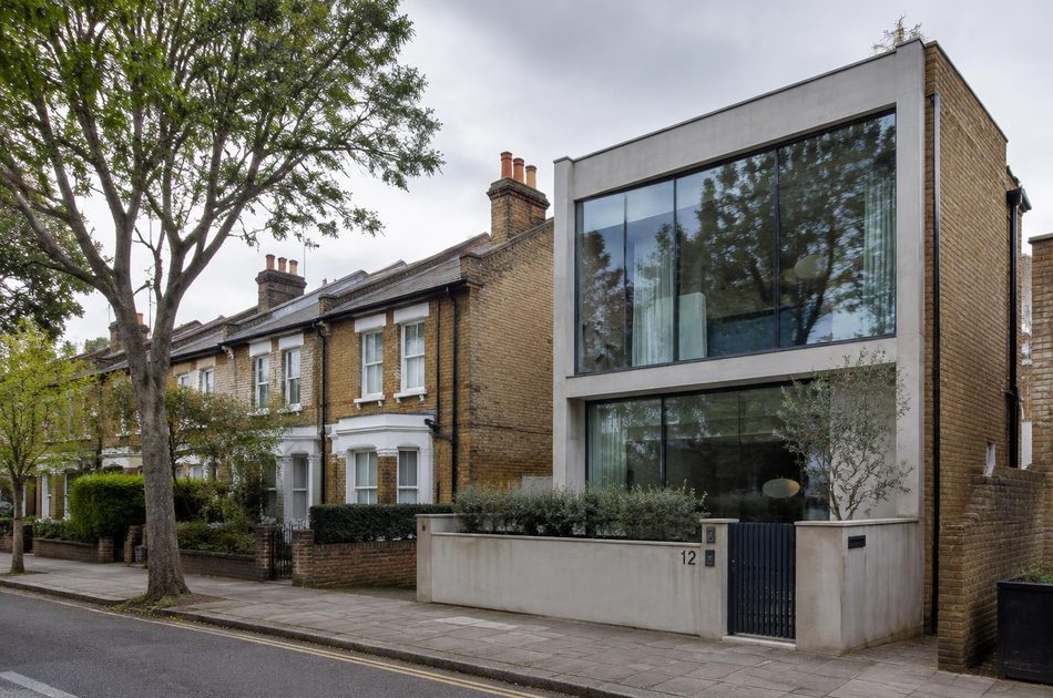 Victorian brick terraces beside a contemporary concrete and glass house in Ladywell